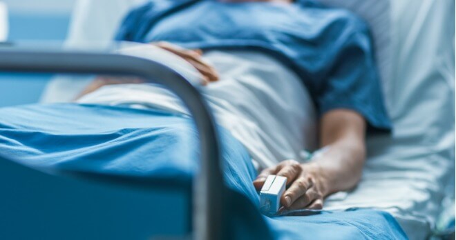 patient lying in a hospital bed